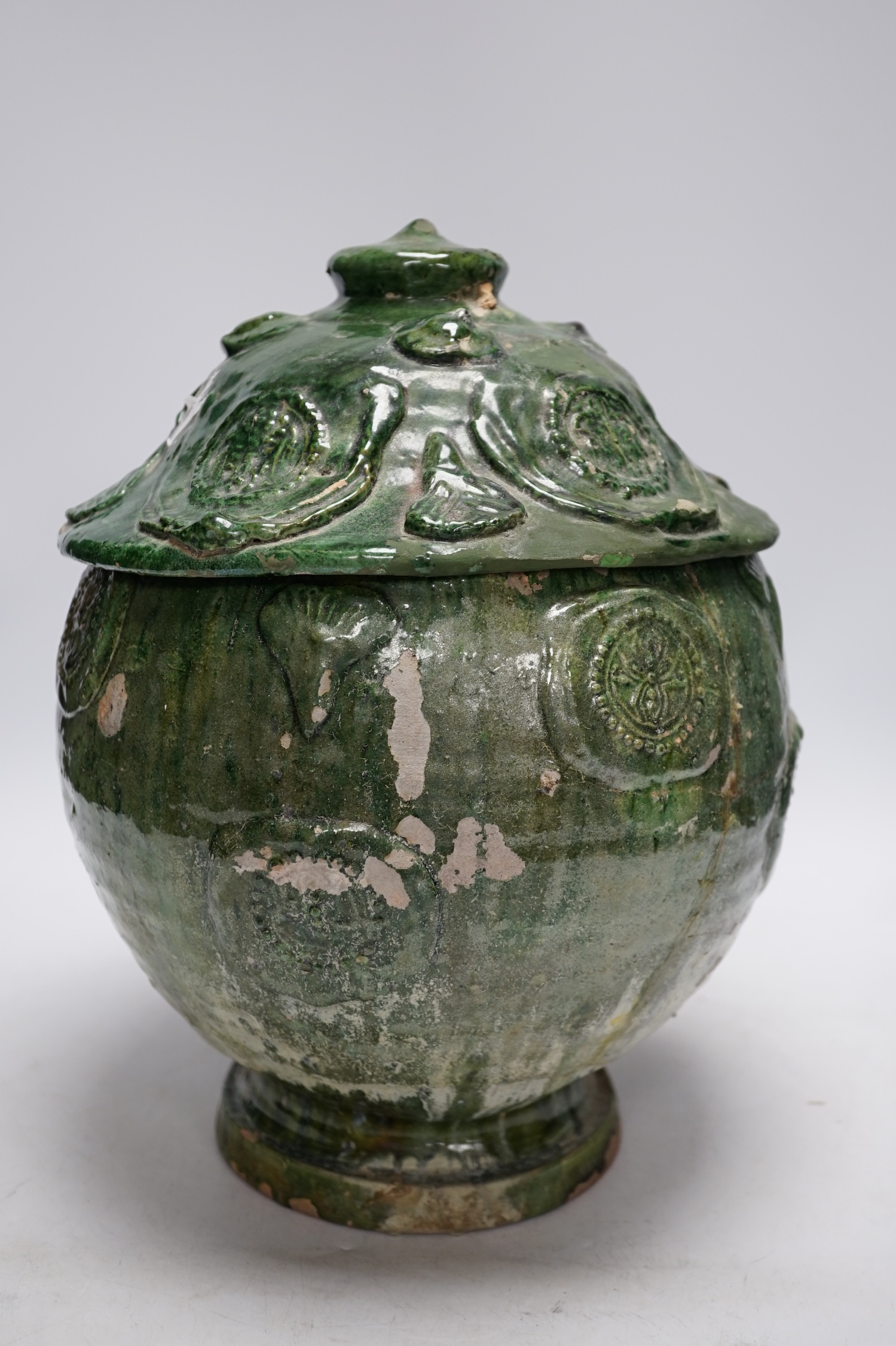 A Chinese Buddhist green glazed jar and cover, Song-Yuan dynasty, 33cm